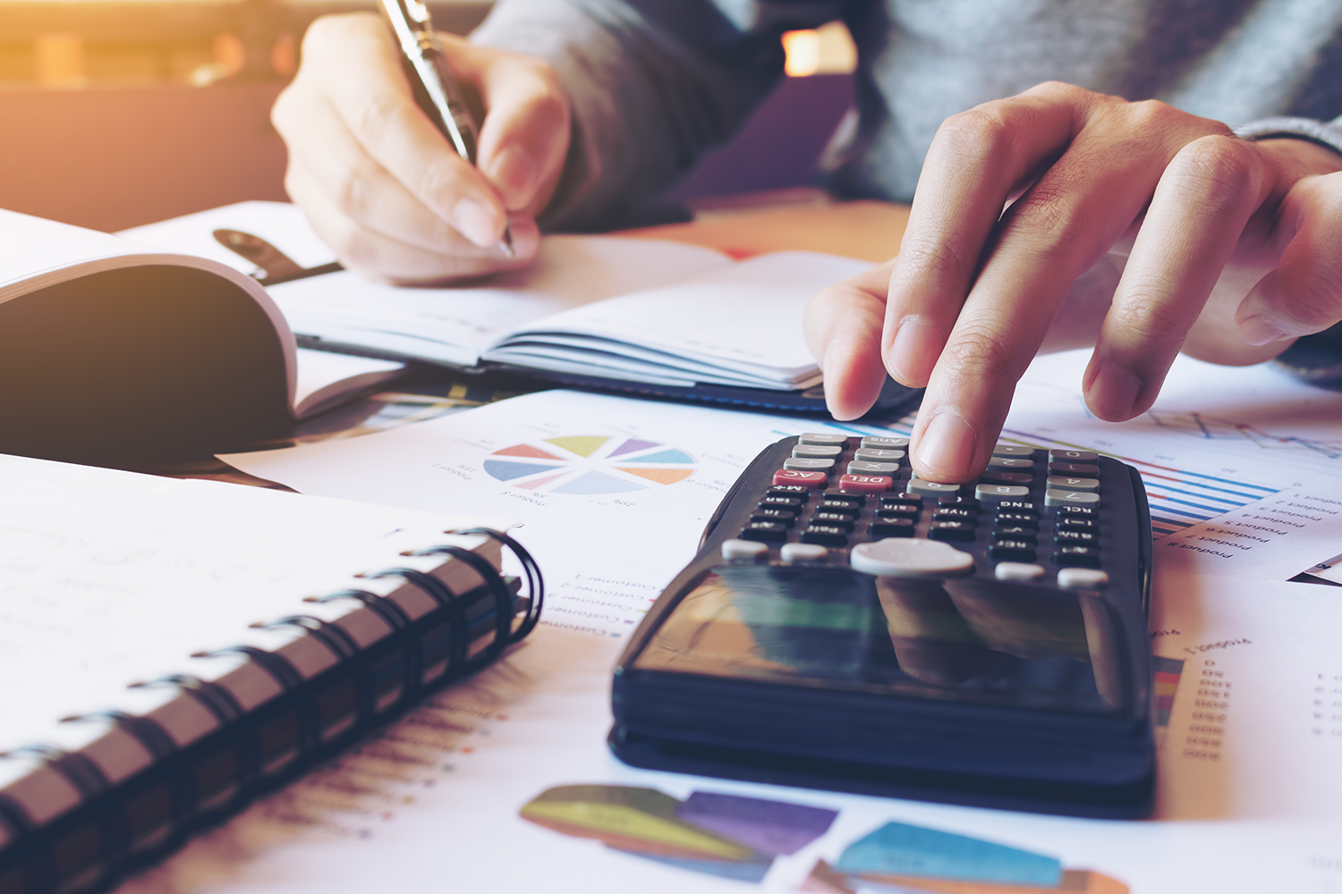 Man using a calculator to record financial records.