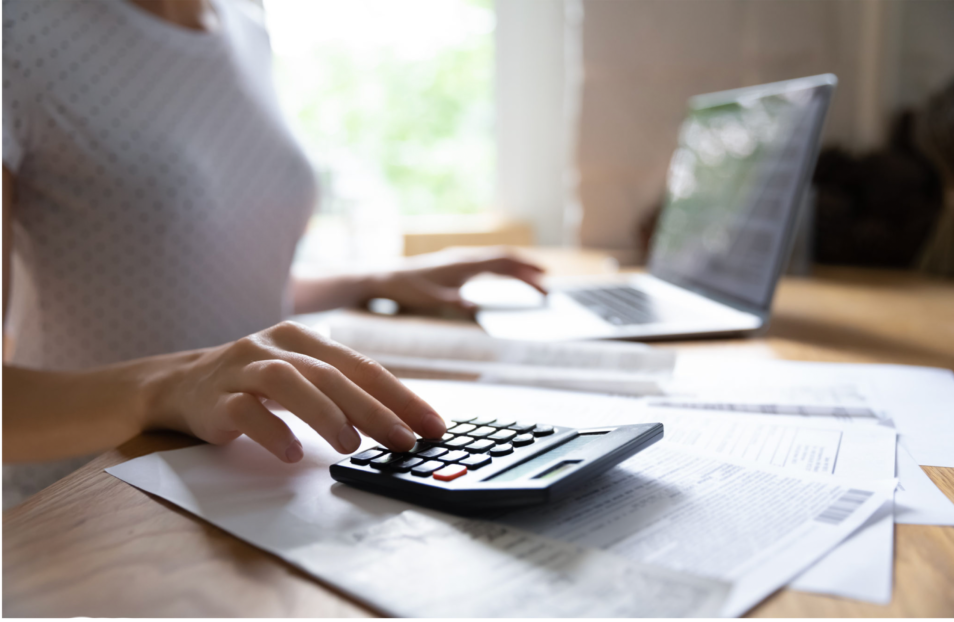 Woman using a calculator to to check finances